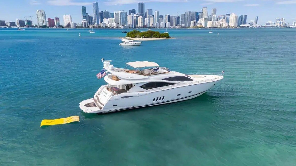 90' Azimut Yacht Charter anchored in Biscayne Bay with the Miami skyline and Magic Carpet water mat.