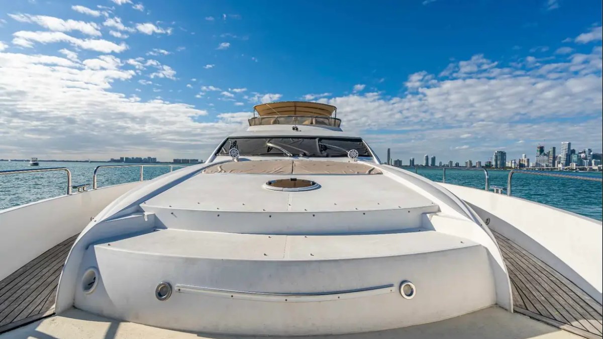 90' Azimut Yacht Charter bow sun pad with expansive foredeck and Miami skyline views.