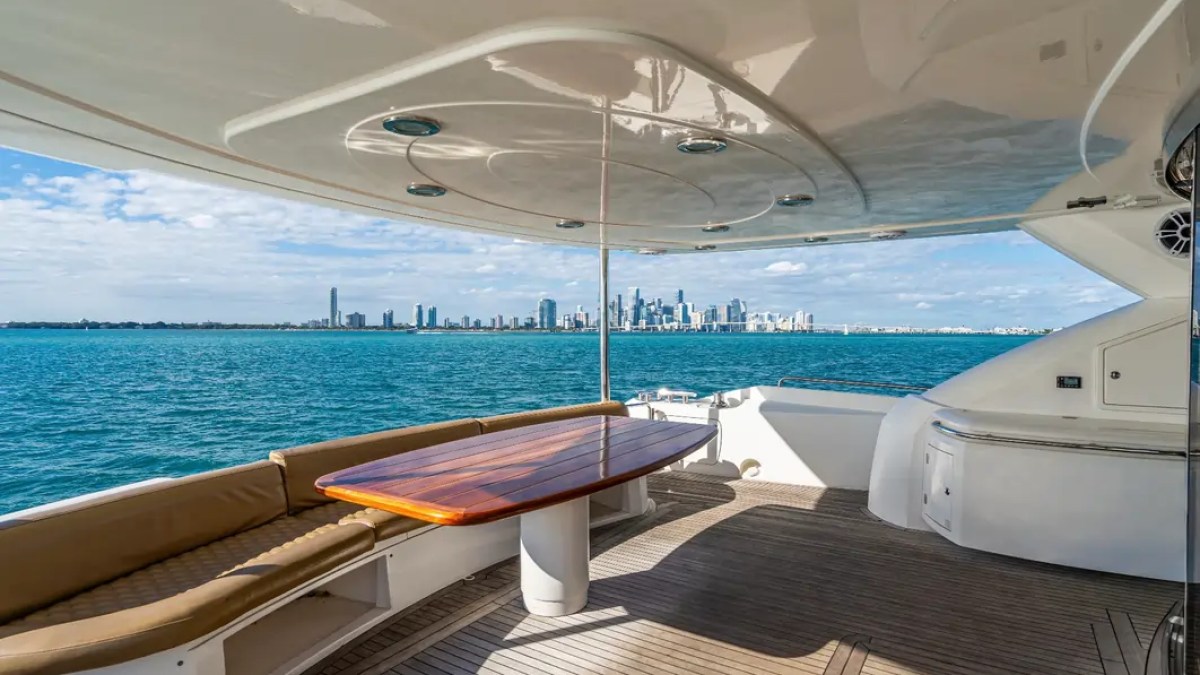 90' Azimut Yacht Charter covered aft deck with outdoor dining and panoramic Miami skyline views.