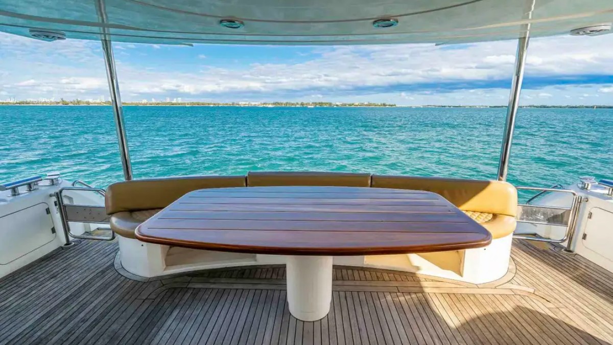 90' Azimut Yacht Charter covered aft dining deck overlooking Biscayne Bay in Miami.