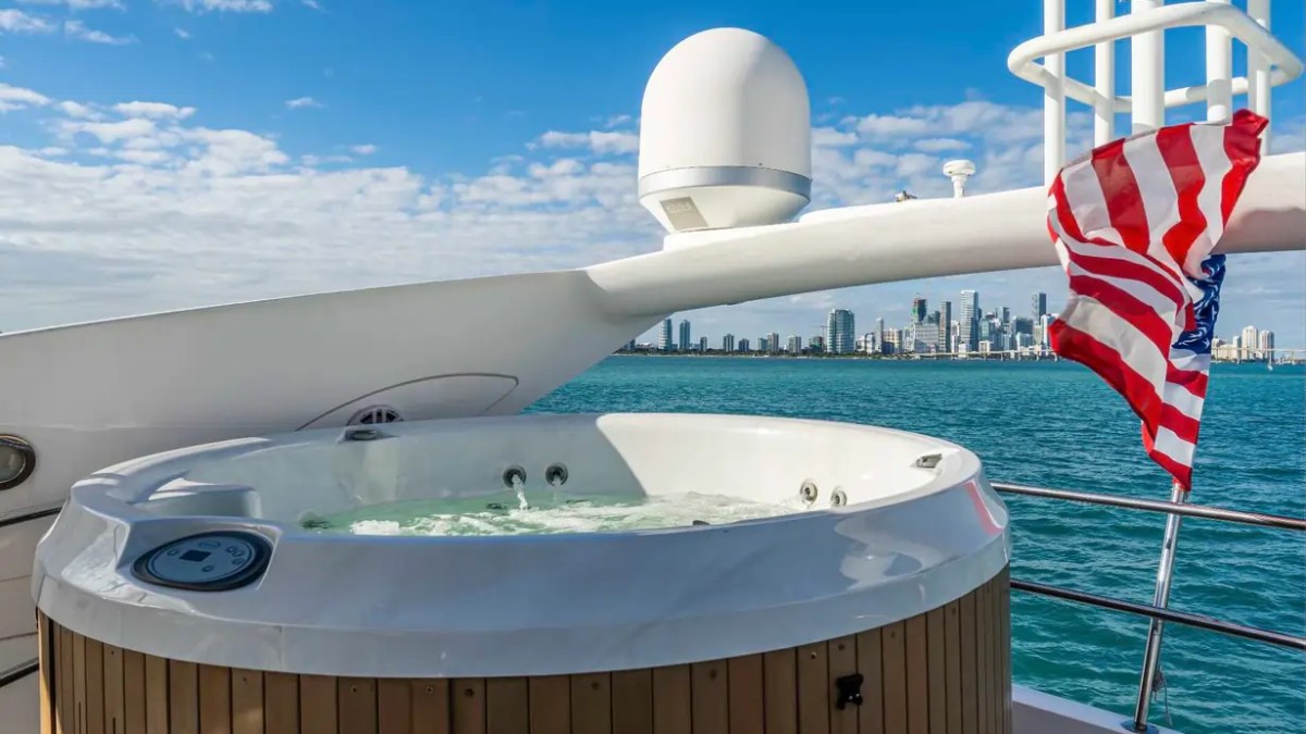 90' Azimut Yacht Charter flybridge Jacuzzi with panoramic Miami skyline and bay views.