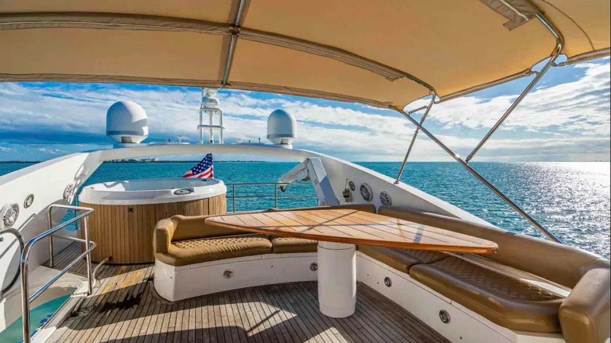 90' Azimut Yacht Charter flybridge lounge with Jacuzzi, shaded dining and panoramic ocean views in Miami.