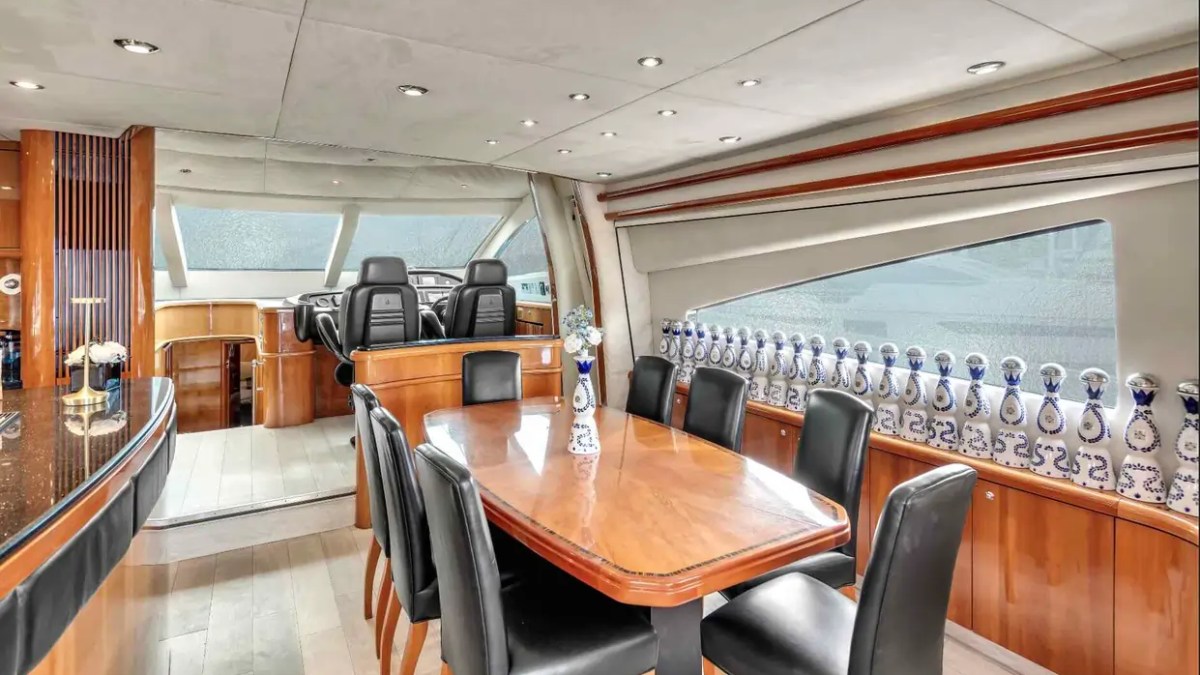 90' Azimut Yacht Charter formal dining salon with panoramic windows and elegant luxury interiors in Miami.