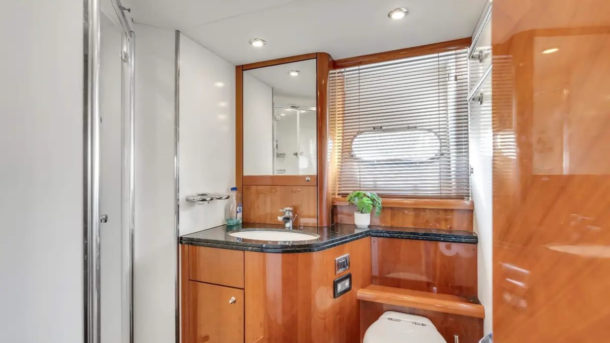 90' Azimut Yacht Charter luxury guest bathroom with granite vanity and private shower in Miami.