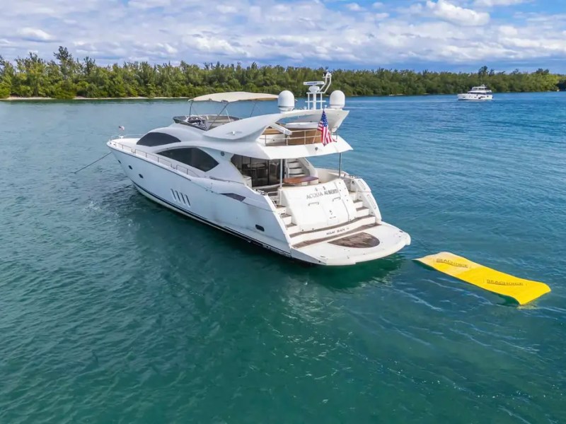 90' Azimut Yacht Charter anchored in Biscayne Bay with a Magic Carpet water mat in Miami.