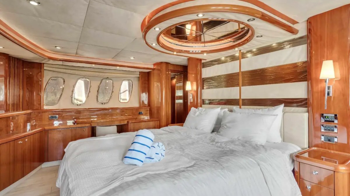 90' Azimut Yacht Charter full-beam master suite with king bed and luxury accommodations in Miami.