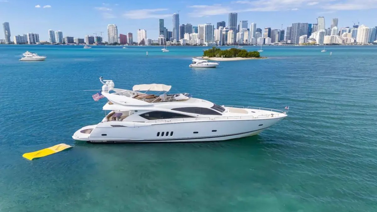 90' Azimut Yacht Charter anchored near a Miami sandbar with the downtown skyline and Magic Carpet in Biscayne Bay.