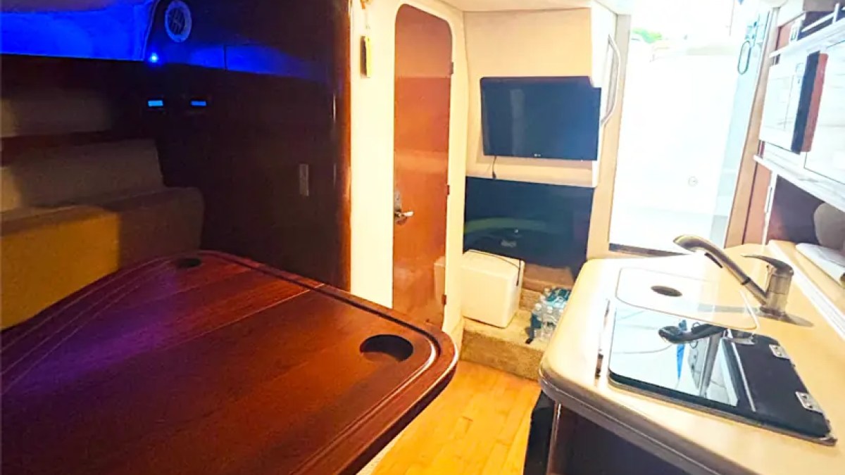 30' SeaRay Boat Rental cabin featuring a spacious dinette, galley, entertainment center, and comfortable lounge area for relaxing cruises around Miami Beach and Biscayne Bay.