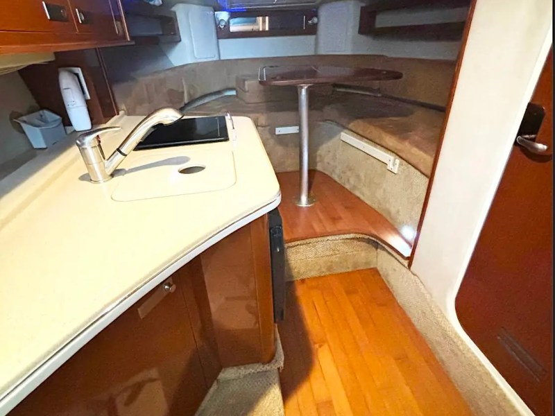 30' SeaRay Boat Rental cabin featuring a compact galley, wraparound dinette, and comfortable lounge seating for relaxing cruises around Miami Beach and Biscayne Bay.