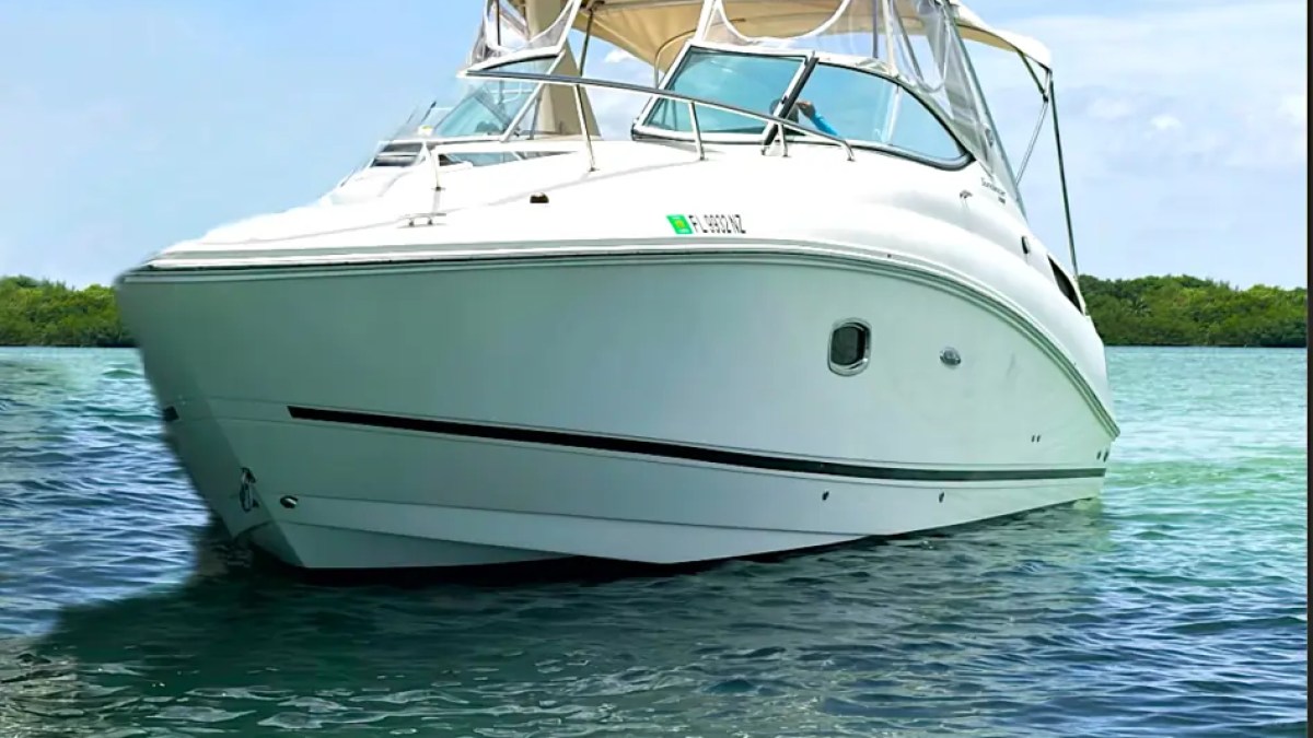 30' SeaRay Boat Rental anchored in the crystal-clear waters of Miami Beach showcasing its spacious bow, sporty profile, and comfortable cruiser design on Biscayne Bay.
