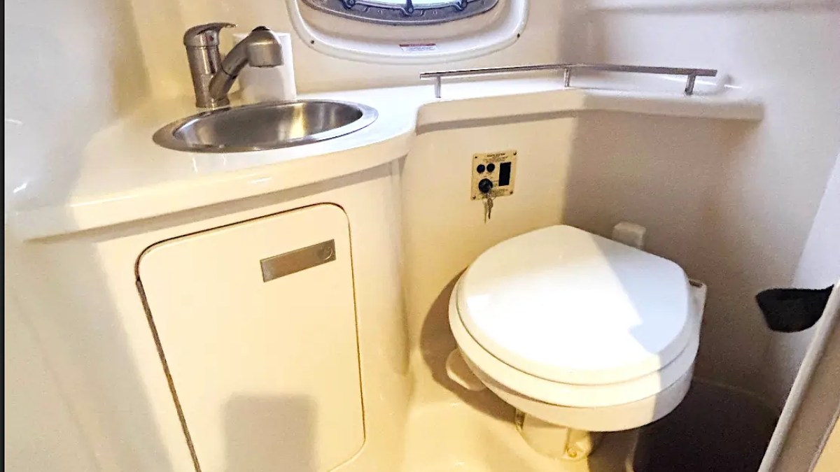 30' SeaRay Boat Rental private marine head featuring a sink, freshwater vanity, and enclosed restroom for added comfort while cruising Miami Beach and Biscayne Bay.