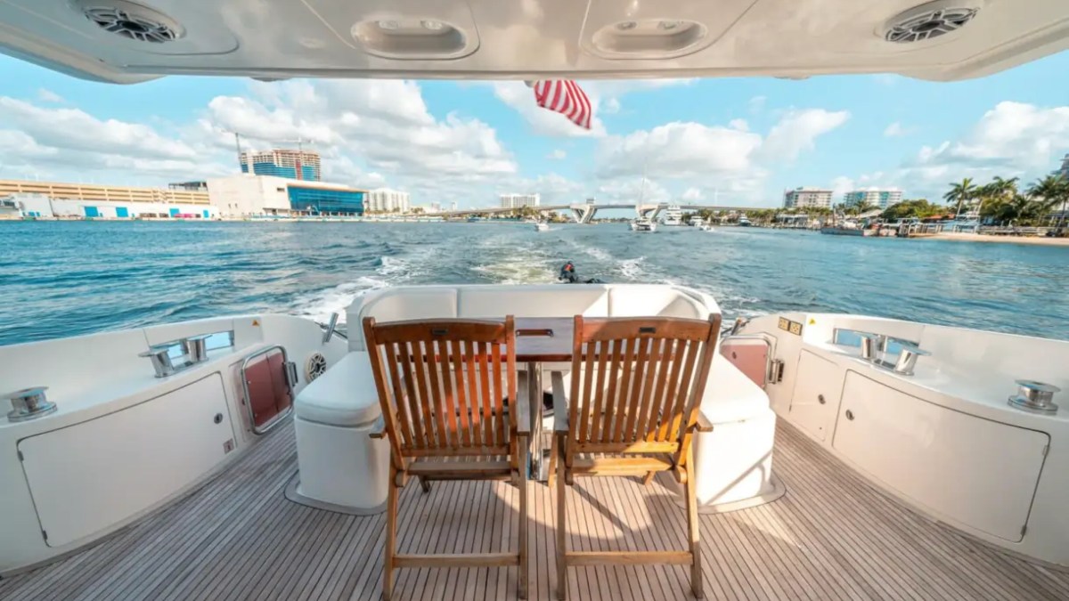 66' Azimut Yacht Charter aft deck dining with Intracoastal Waterway views in Miami Beach.