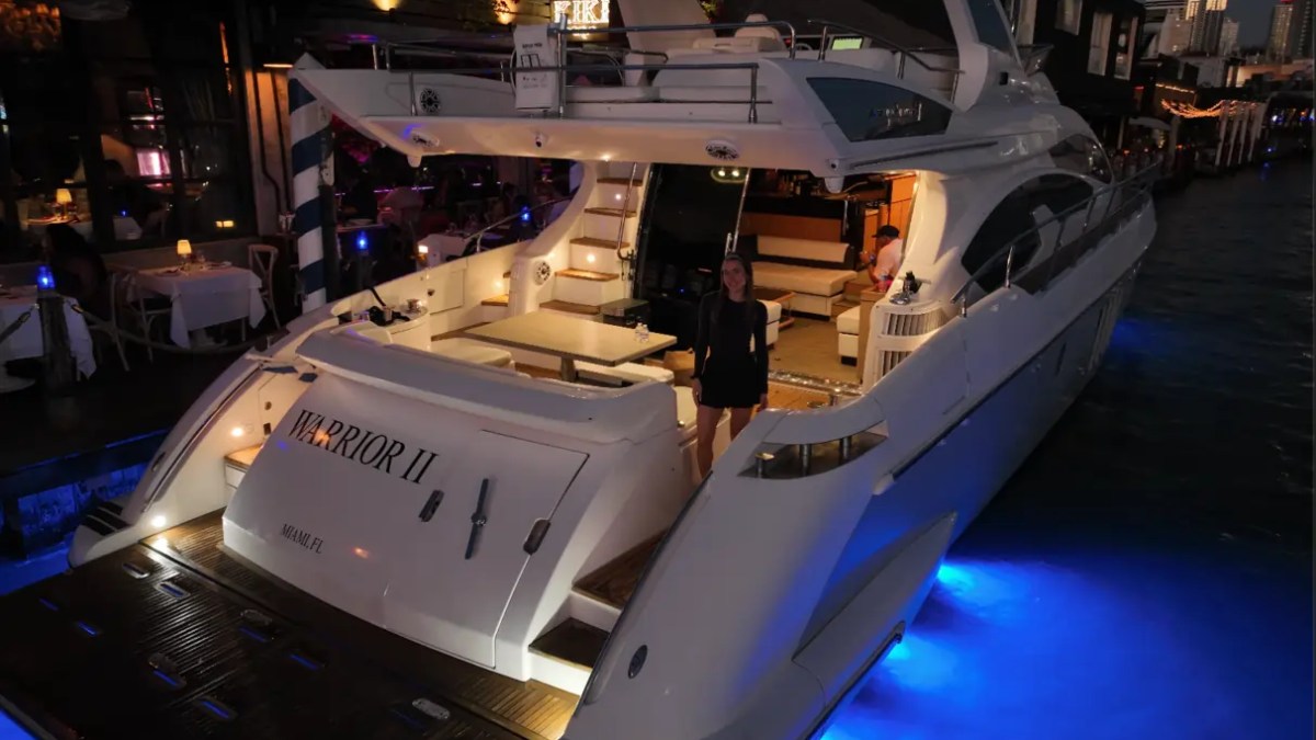 66' Azimut Yacht Charter illuminated aft deck & swim platform at night in Miami Beach.