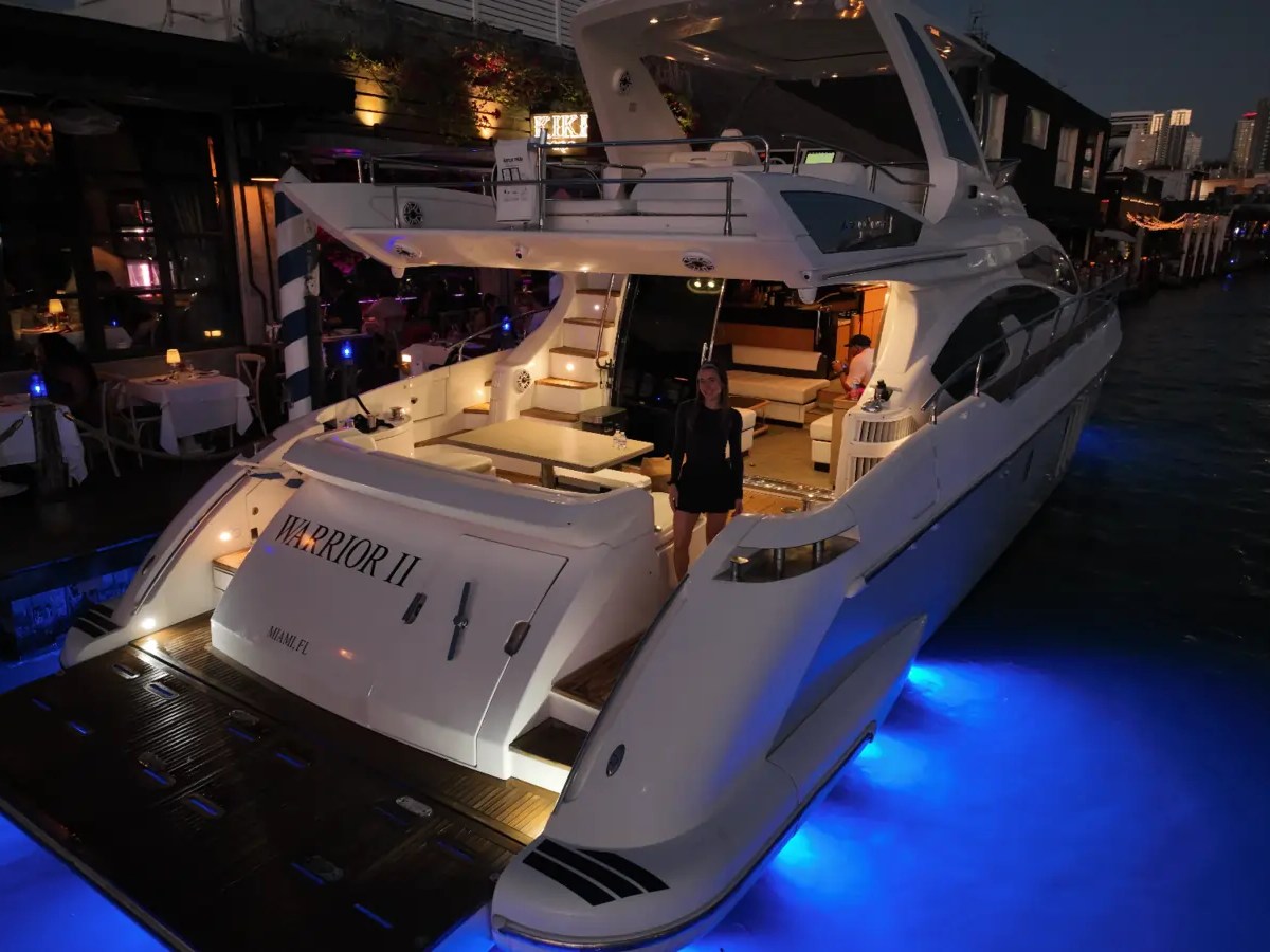 66' Azimut Yacht Charter illuminated aft deck & swim platform at night in Miami Beach.