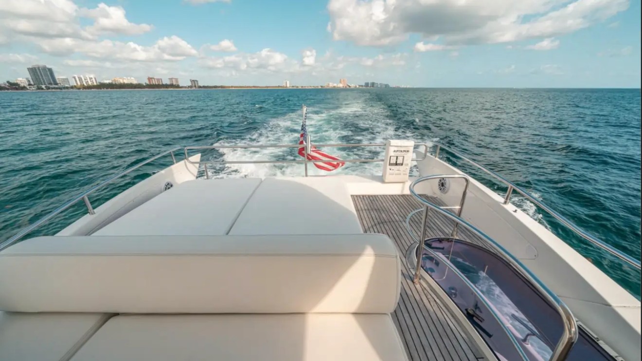 66' Azimut Yacht Charter flybridge sun pad with panoramic ocean views in Miami Beach.