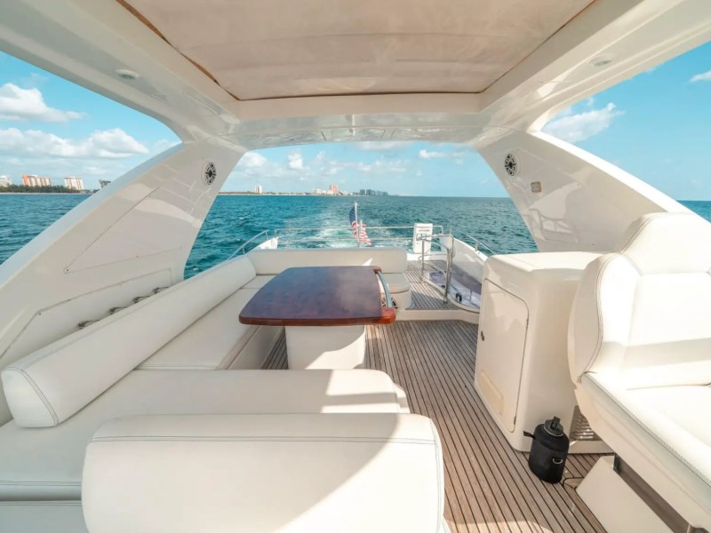 66' Azimut Yacht Charter flybridge lounge with outdoor dining in Miami Beach.