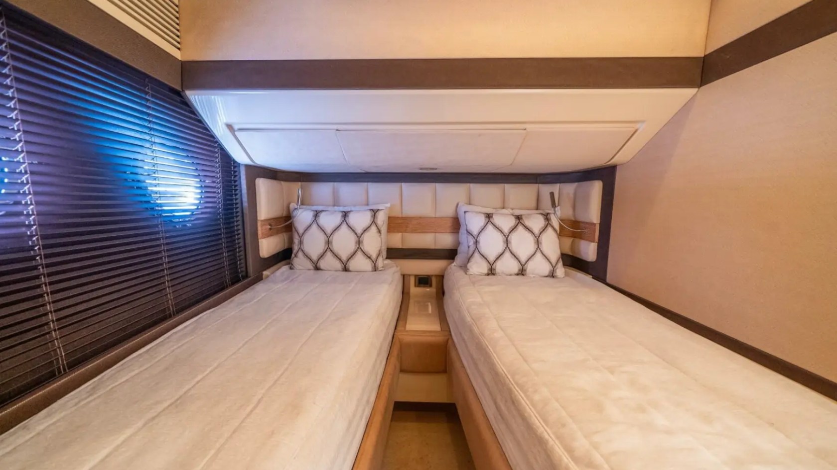 66' Azimut Yacht Charter guest cabin with twin beds in Miami Beach.
