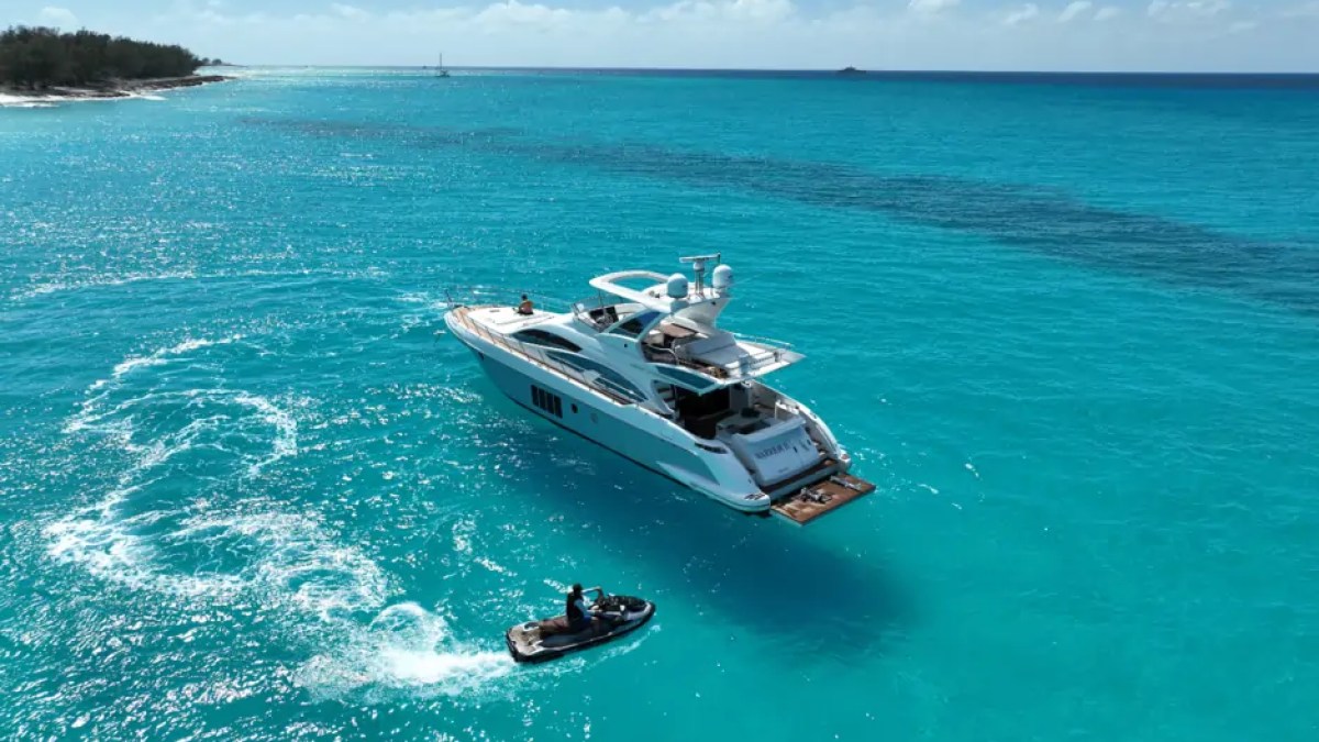 66' Azimut Yacht Charter anchored in turquoise waters with jet ski in Miami Beach.