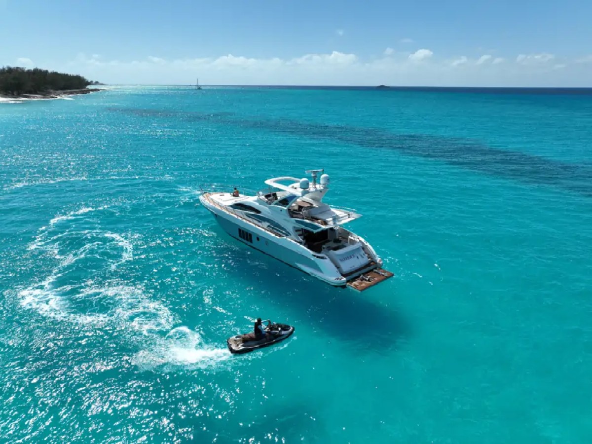 66' Azimut Yacht Charter anchored in turquoise waters with jet ski in Miami Beach.
