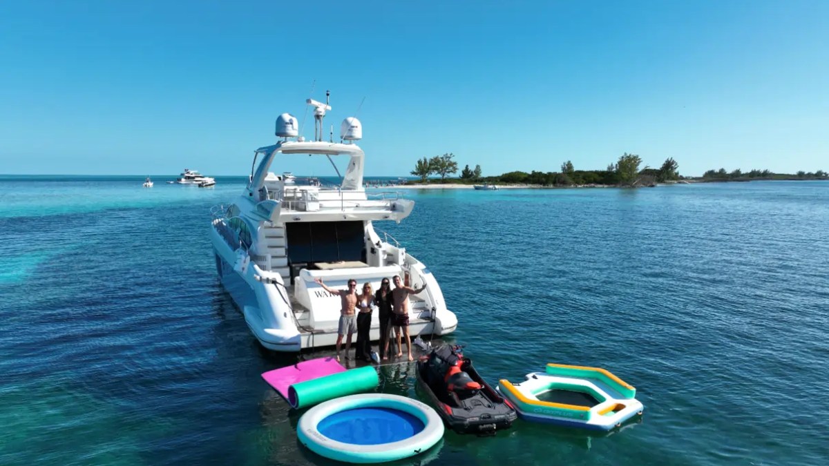 66' Azimut Yacht Charter with jet ski & water toys anchored in Miami Beach.
