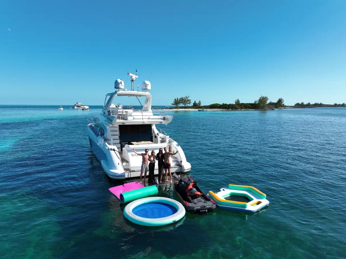 66' Azimut Yacht Charter with jet ski & water toys anchored in Miami Beach.