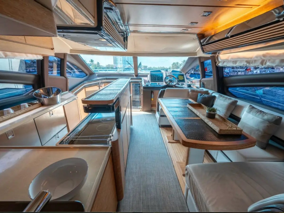 66' Azimut Yacht Charter open-concept salon, galley & helm in Miami Beach.