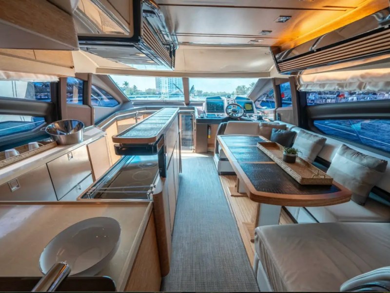 66' Azimut Yacht Charter open-concept salon, galley & helm in Miami Beach.