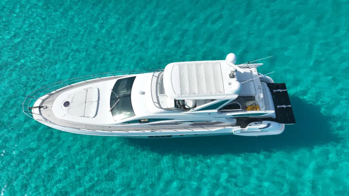 66' Azimut Yacht Charter top-down aerial drone view over crystal-clear waters in Miami Beach.
