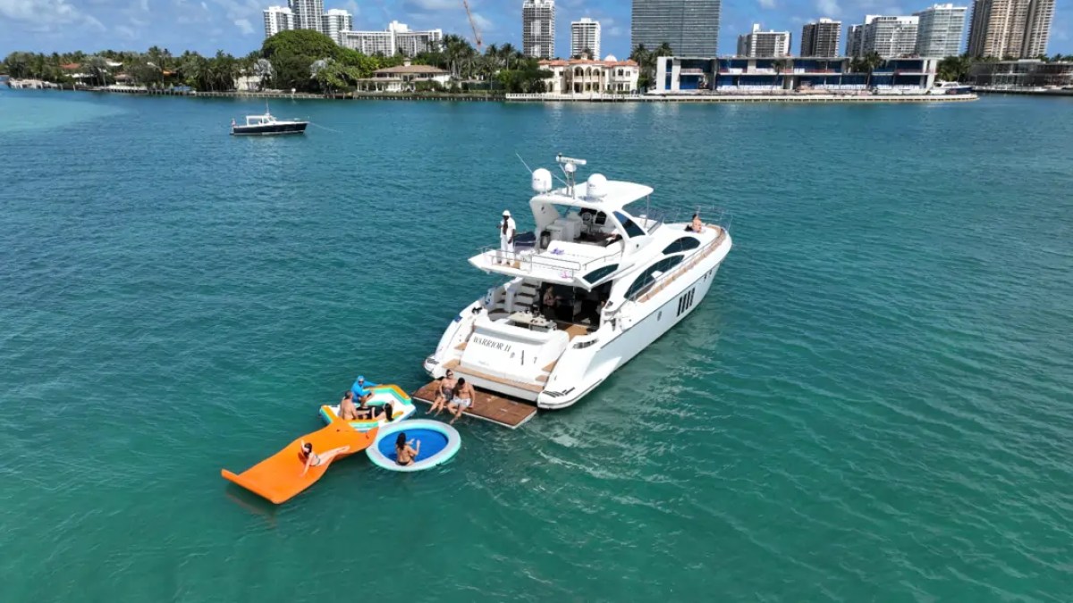66' Azimut Yacht Charter anchored with water toys in Miami Beach.
