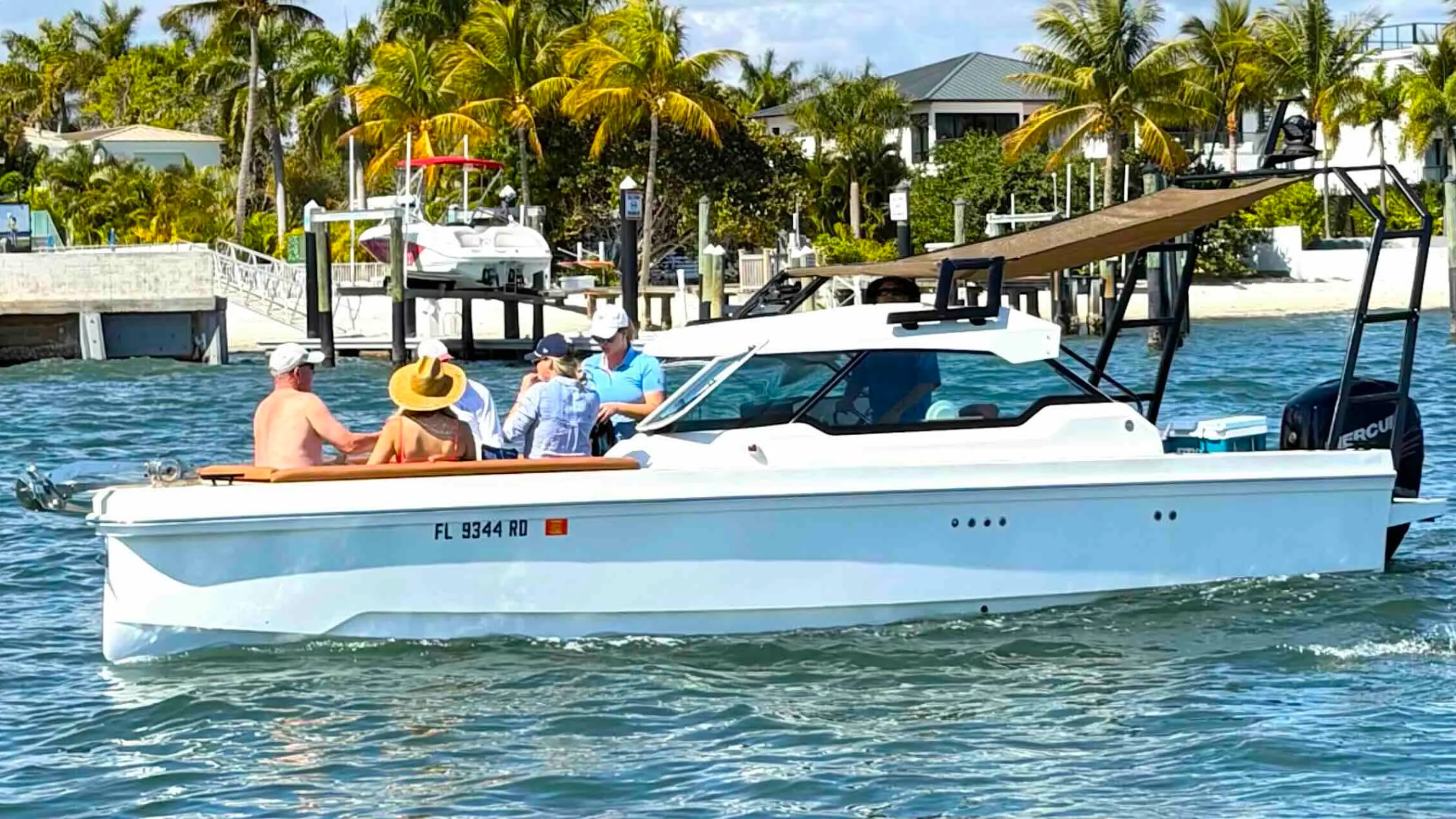 26' Axopar Boat Rental cruising with guests along the tropical Intracoastal Waterway in Riviera Beach, Florida.