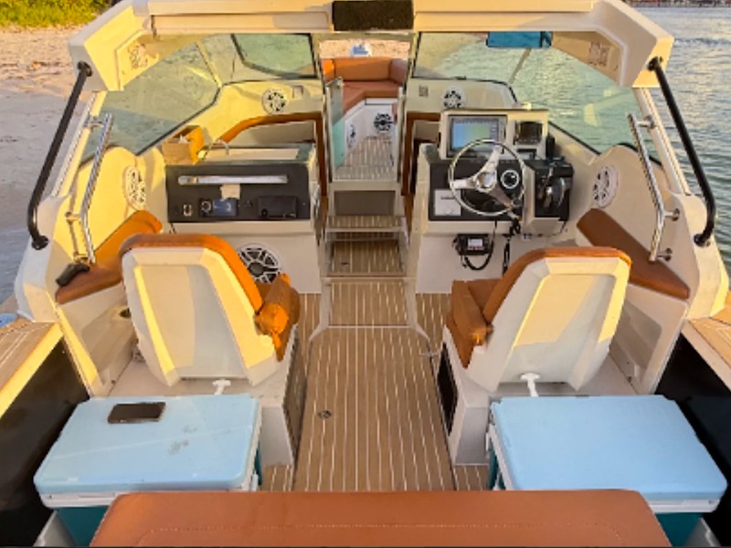 Interior helm and cockpit seating aboard a 26' Axopar Boat Rental in Riviera Beach, Florida.