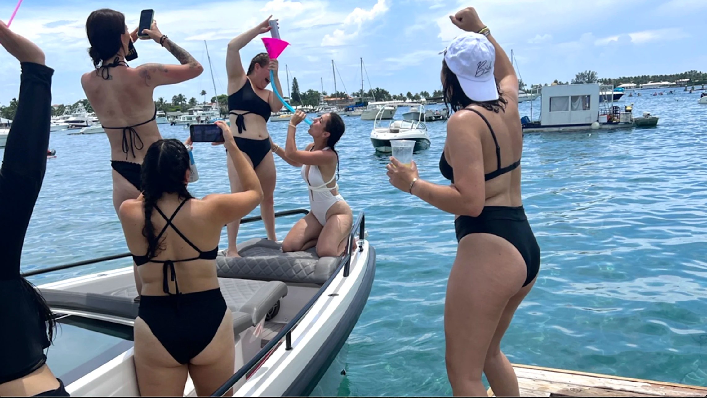 Bachelorette party enjoying a fun day aboard a 37' Axopar Boat Rental near a Riviera Beach sandbar.