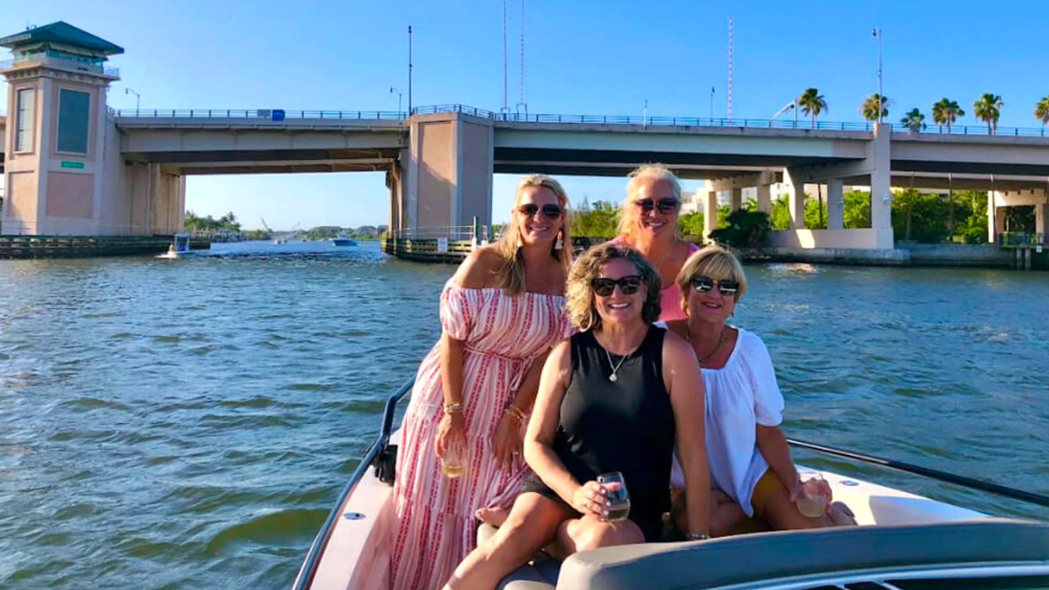 Friends enjoying a 37' Axopar Boat Rental near the Riviera Beach bridge on the Intracoastal Waterway.