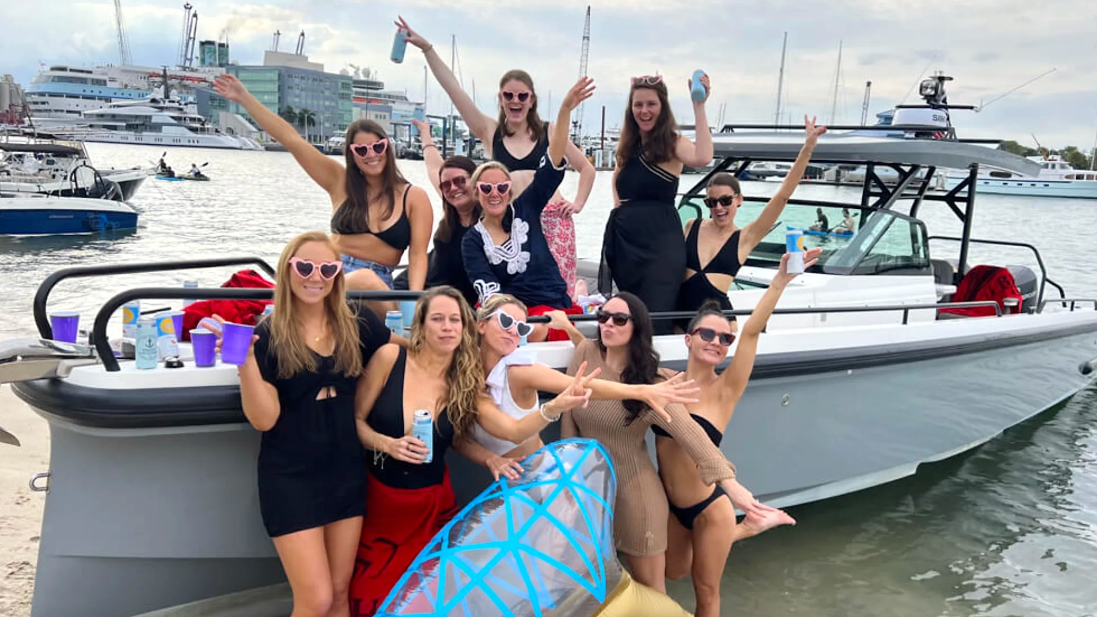 Friends celebrating aboard a 37' Axopar Boat Rental during a Riviera Beach boating adventure.