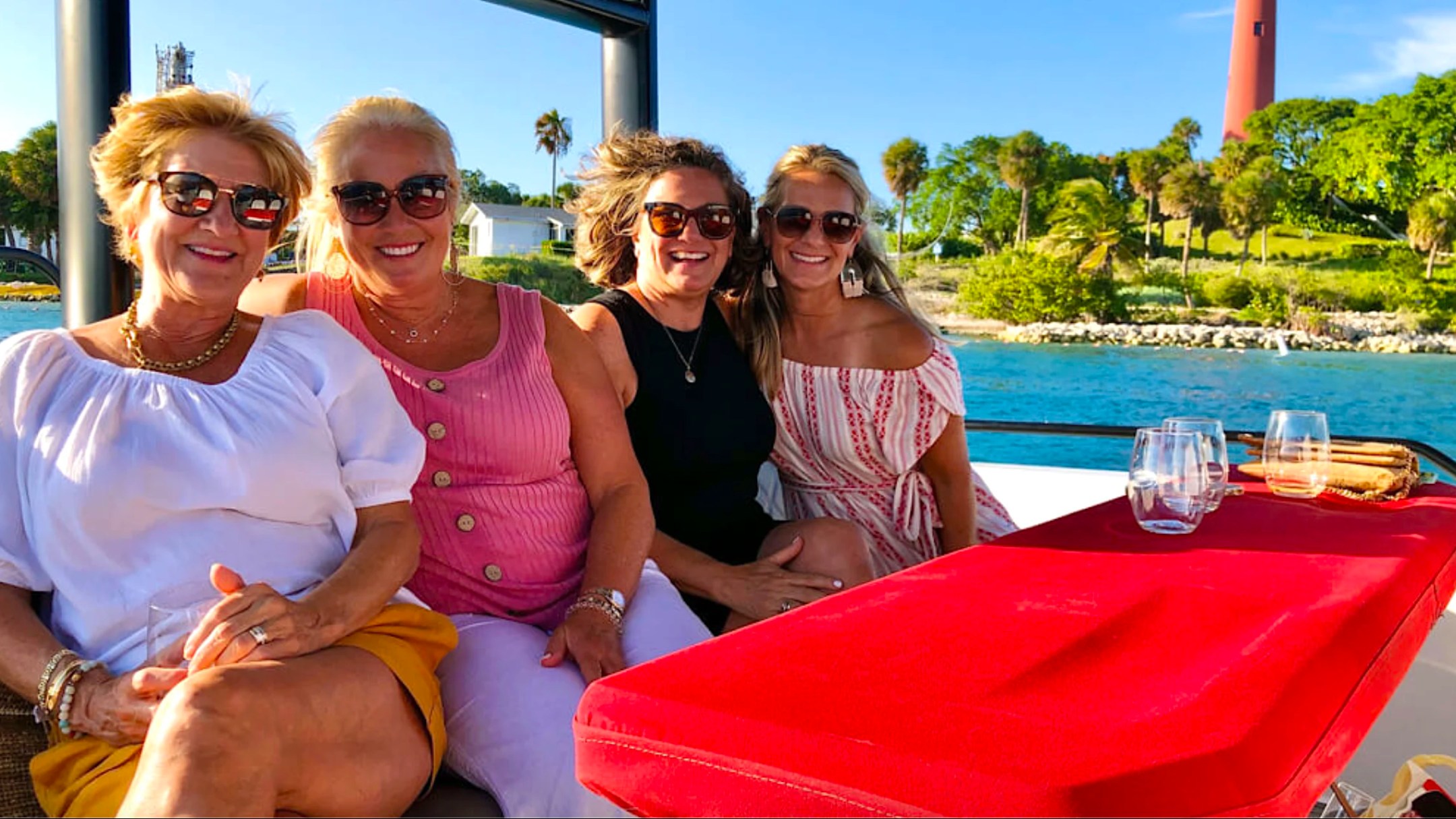 Friends enjoying a 37' Axopar Boat Rental near Jupiter Inlet Lighthouse during a Riviera Beach boating trip.
