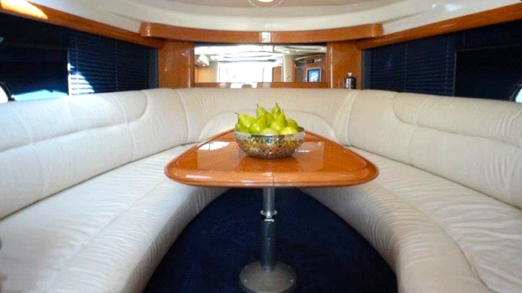 41' Cranchi Boat Rental cabin lounge with wraparound seating and dining table in Riviera Beach.
