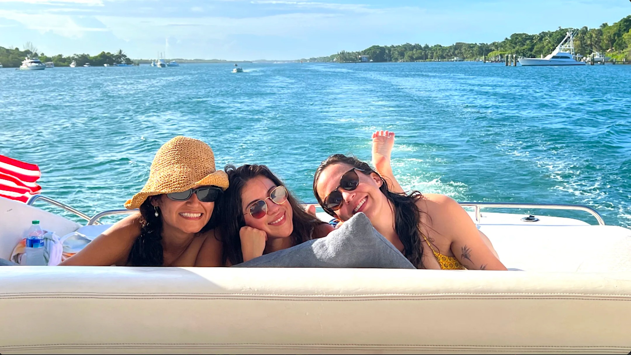 Friends relaxing aboard a 41' Cranchi Boat Rental cruising the Intracoastal Waterway near Riviera Beach.