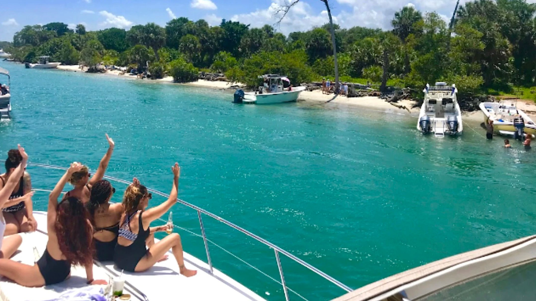 Guests enjoying Peanut Island from a 41' Cranchi Boat Rental near Riviera Beach with crystal-clear turquoise water.
