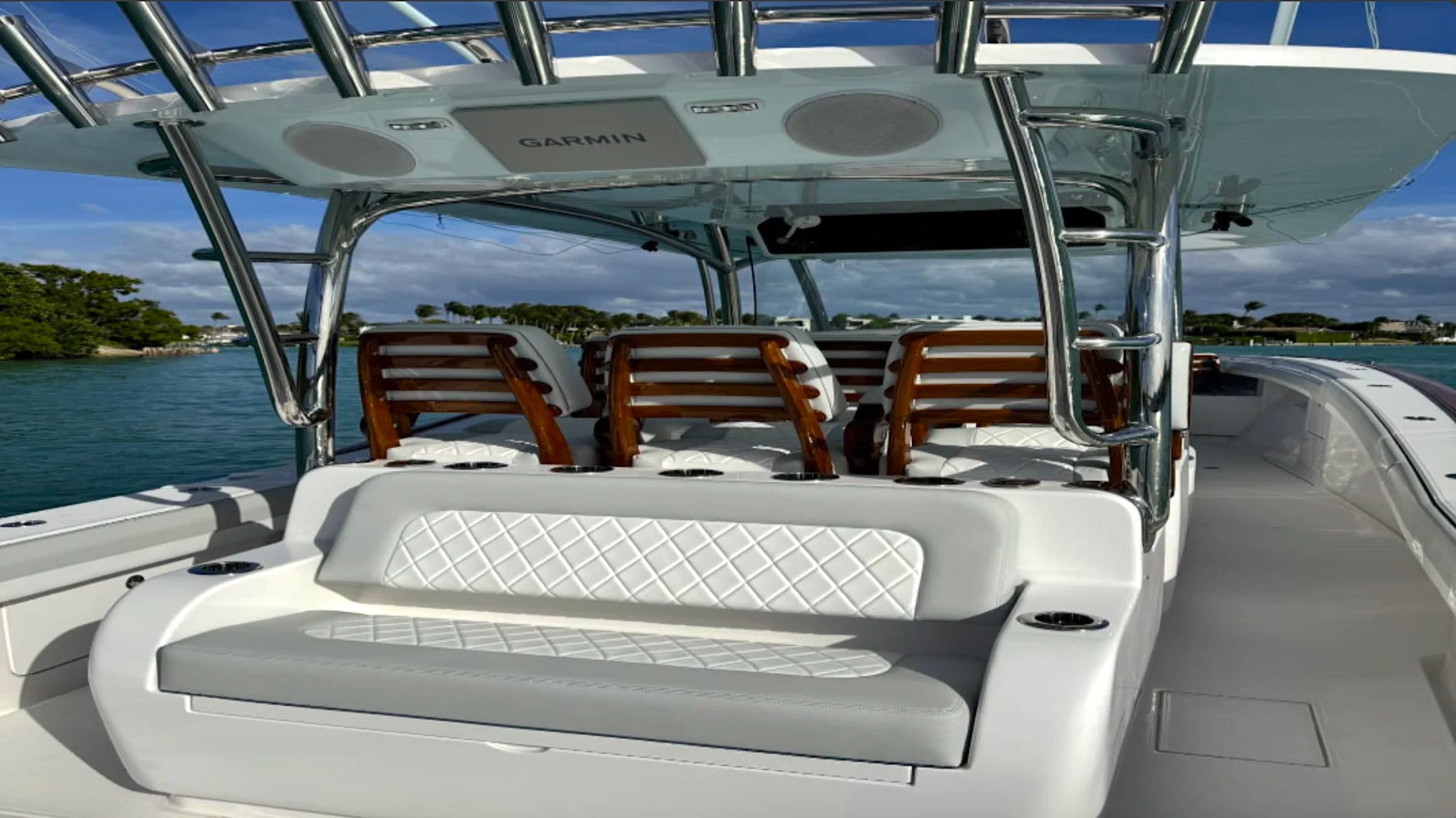 Shaded cockpit lounge aboard the 43' Mag Bay Boat Rental in Riviera Beach with premium bench seating and Garmin-equipped hardtop.