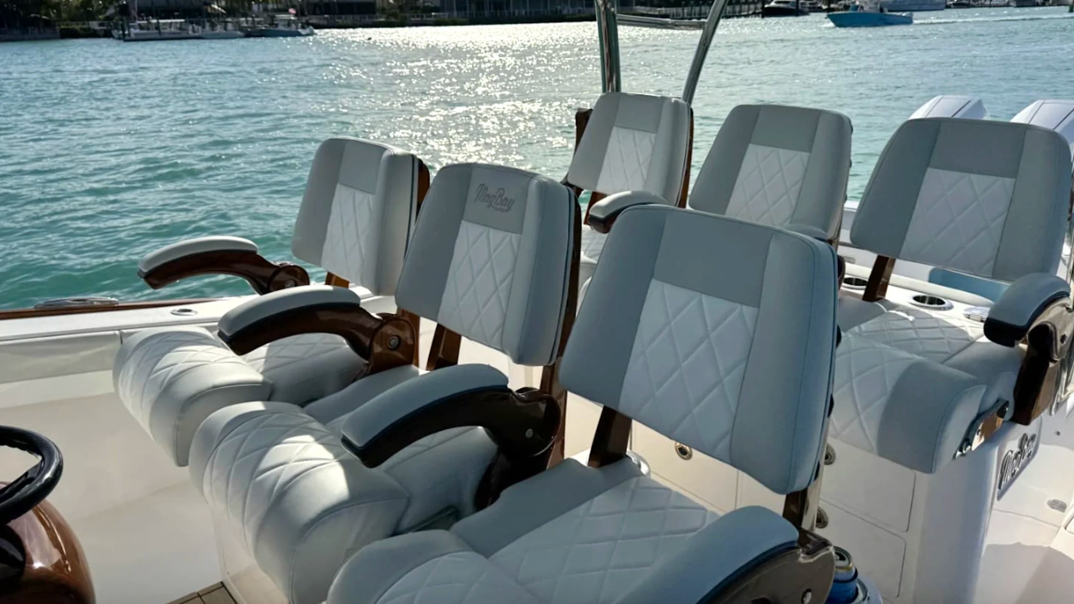 Premium captain's chairs aboard a luxury Palm Beach Fishing Charter boat with diamond-stitched seating.