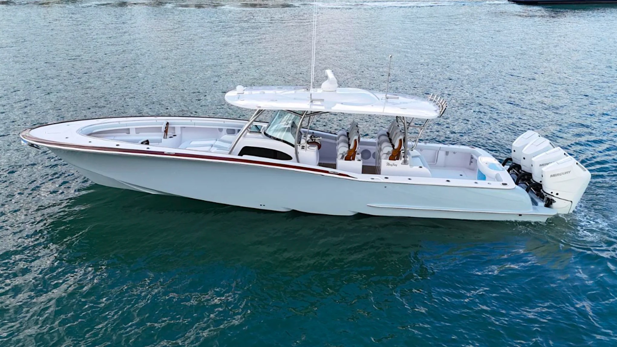 Side profile of the 43' Mag Bay Boat Rental in Riviera Beach featuring triple Mercury outboards and luxury center console design.