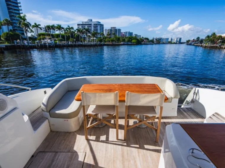 50' Beneteau Yacht Charter aft cockpit with teak dining table cruising through Delray Beach Florida.