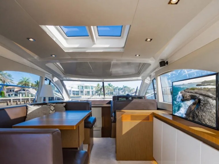 50' Beneteau Yacht Charter salon with panoramic windows and elegant dining area in Delray Beach Florida.