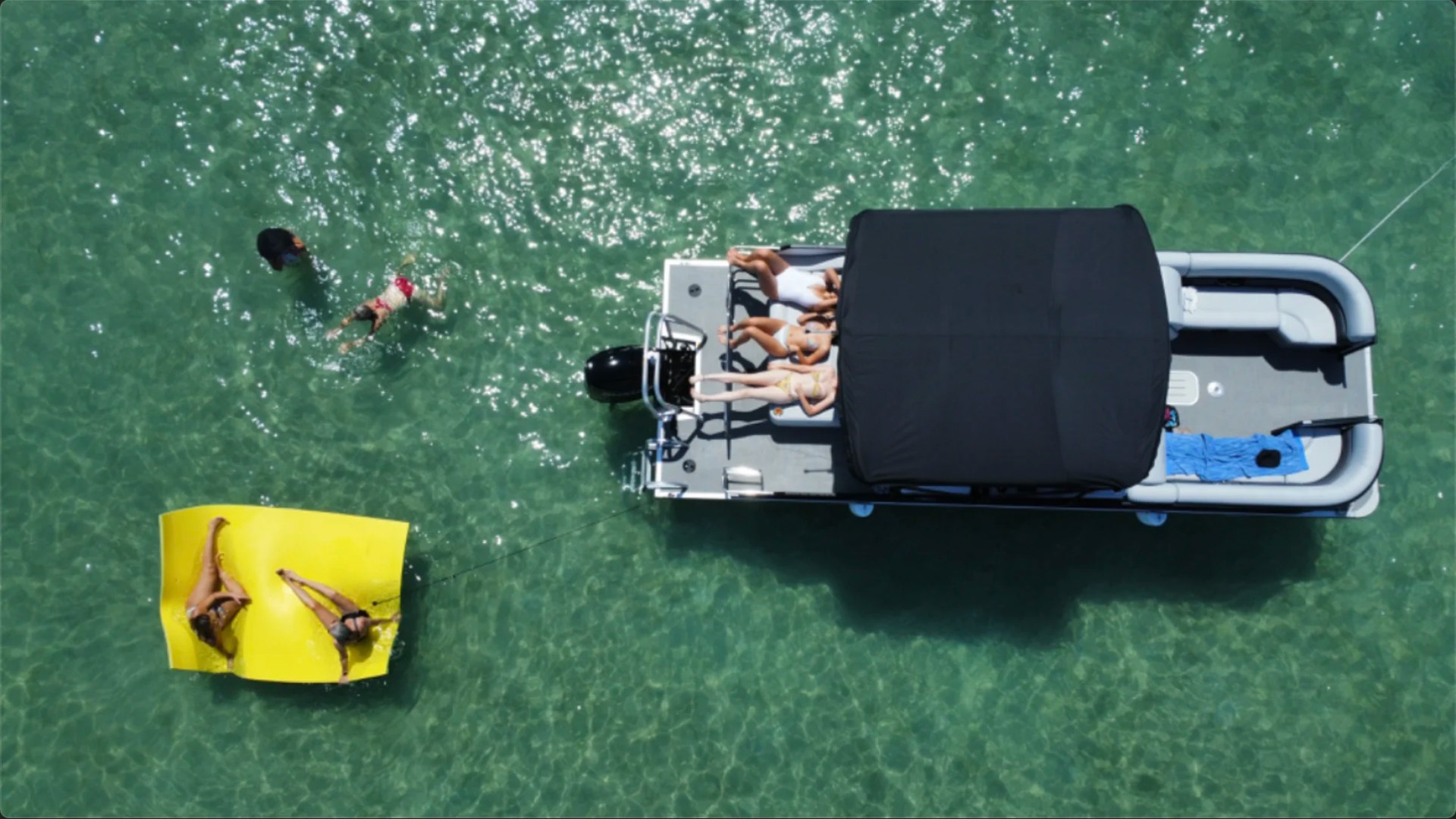 25' Bentley Boat Rental aerial view at a Hollywood Florida sandbar with guests relaxing and swimming in crystal-clear water.