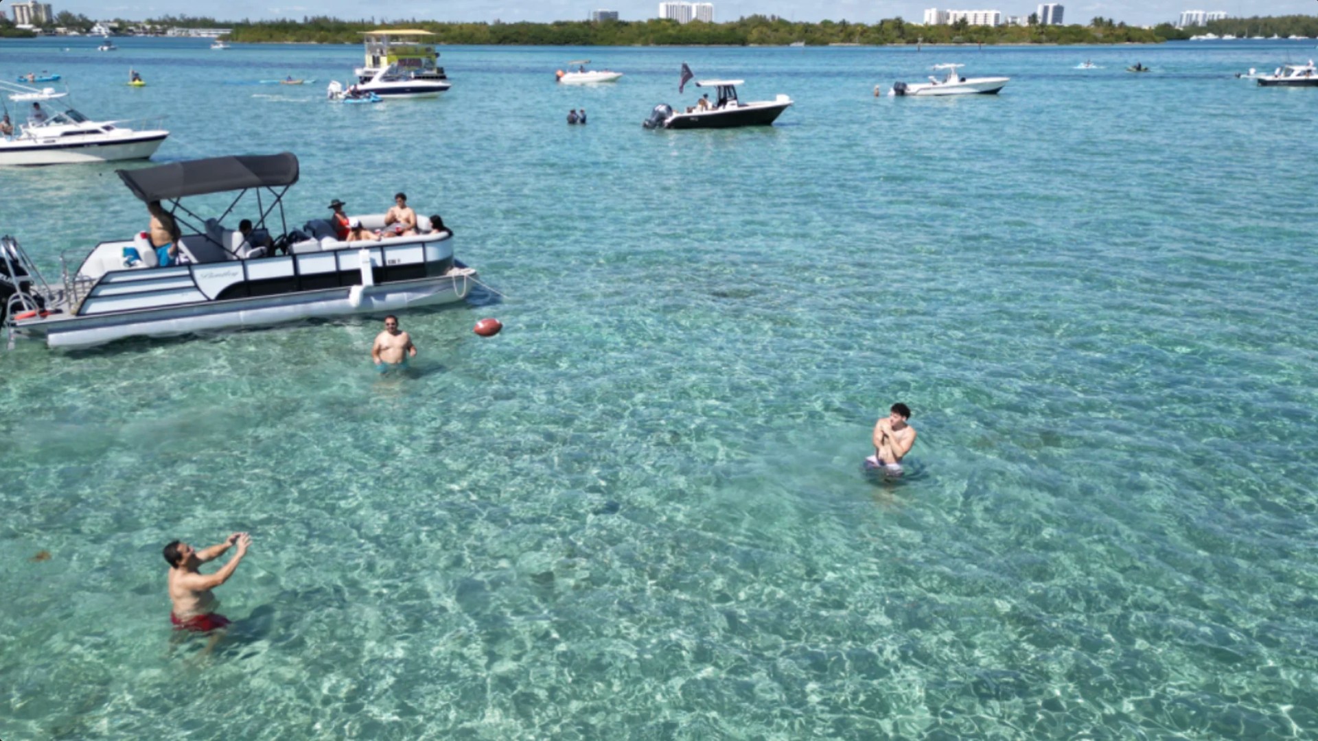 25' Bentley Boat Rental anchored at a popular Hollywood Florida sandbar with guests enjoying crystal-clear water.