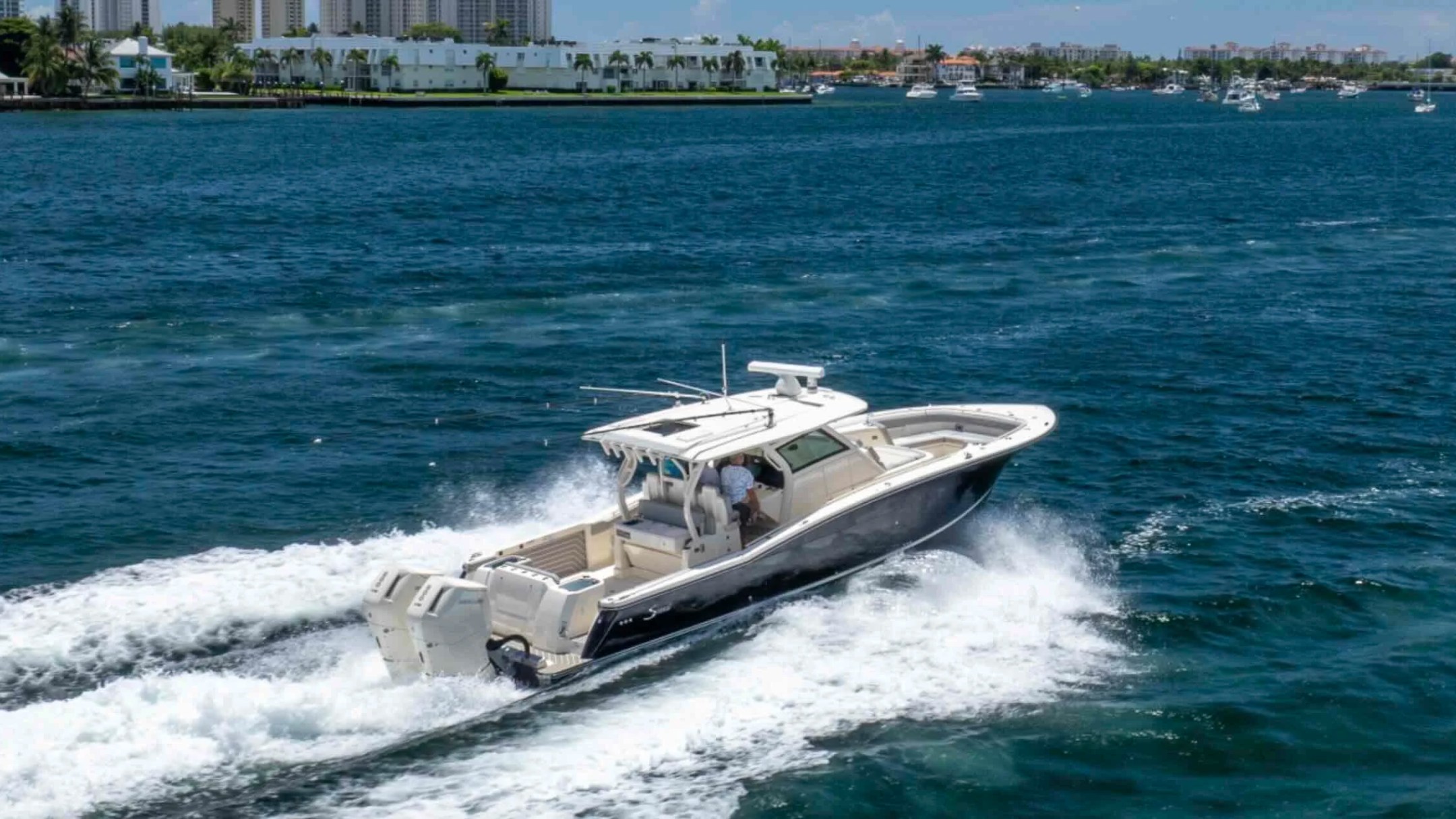 43' Scout Boat Rental cruising through Palm Beach waters with twin Mercury outboards and luxury center console design.