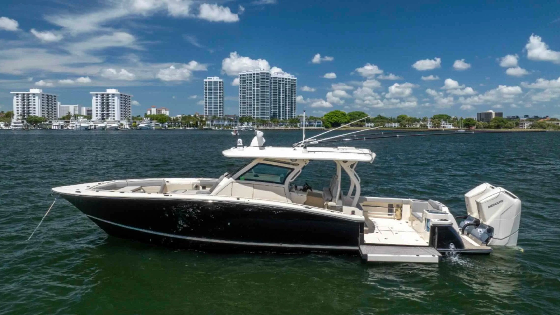 43' Scout Boat Rental anchored in Palm Beach with luxury waterfront skyline.