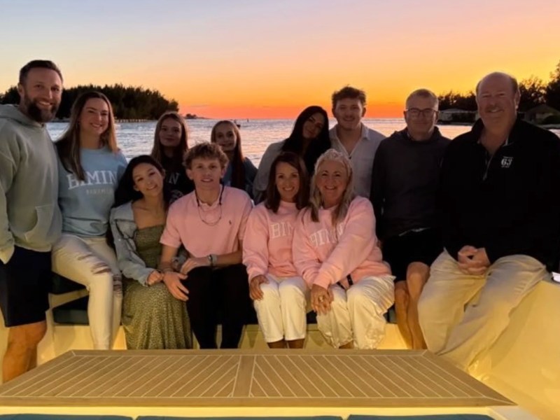 Family enjoying a sunset gathering aboard a 50' DeAntonio Yacht Charter in Palm Beach with waterfront views creating a memorable evening on South Florida's Atlantic coastline.