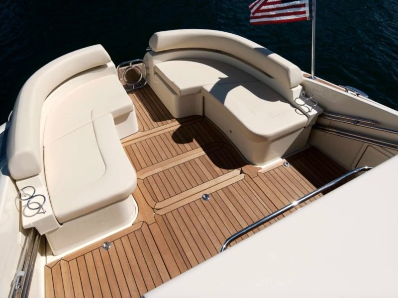 Spacious aft cockpit aboard a 38' Chris-Craft Boat Rental in Riviera Beach with wraparound seating and teak decking.