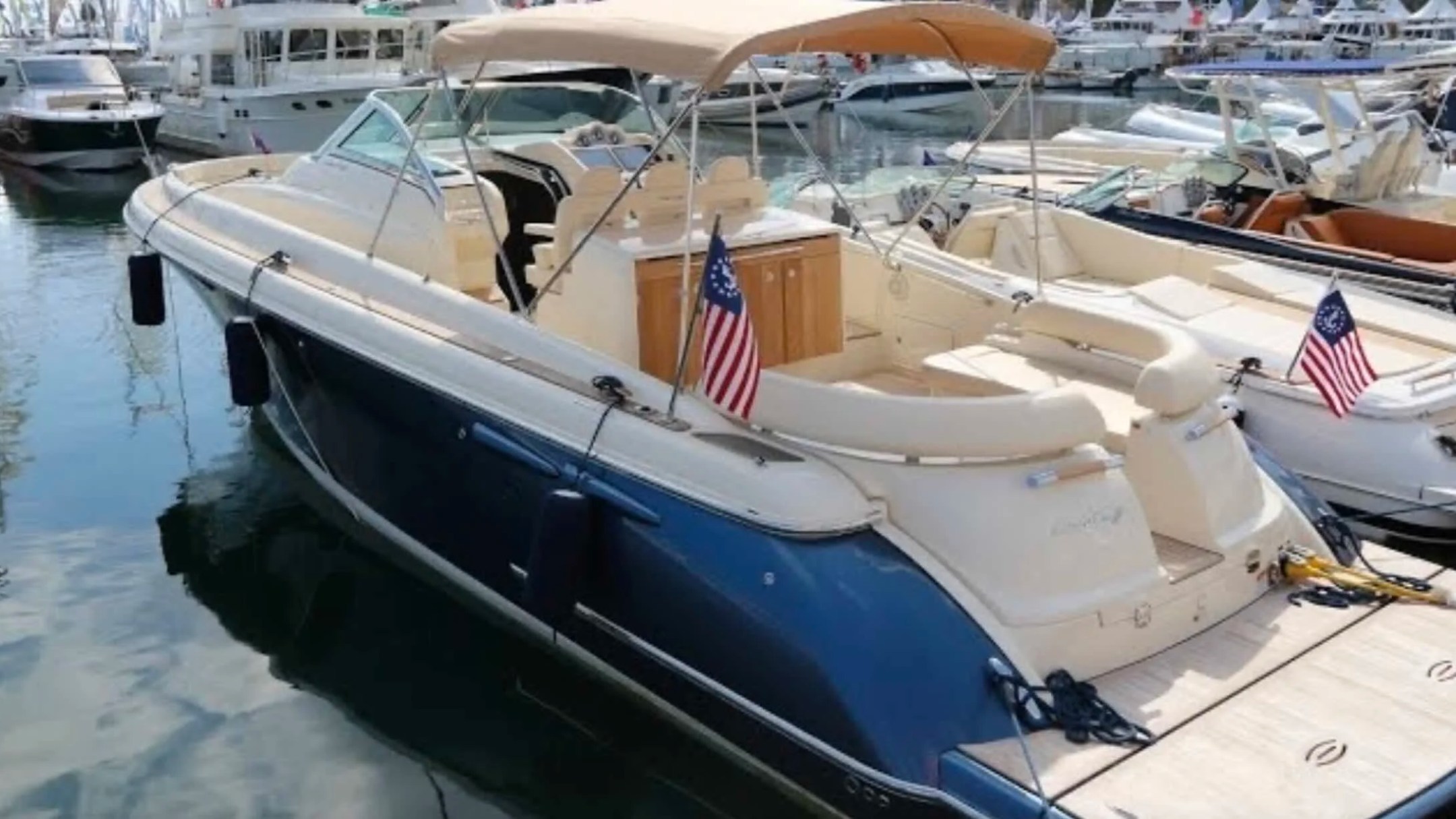38' Chris-Craft Boat Rental docked at Riviera Beach Marina showcasing its spacious cockpit, elegant styling and comfortable day charter layout.